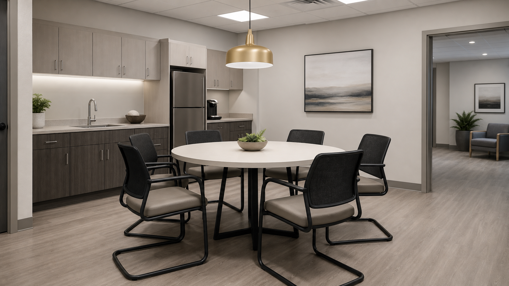 Healthcare staff break room with durable commercial furniture on open leg bases, easy-clean surfaces throughout
