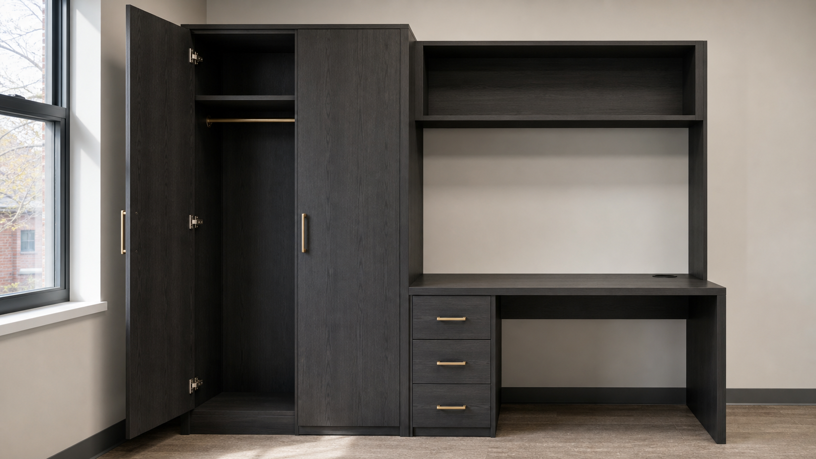 Student housing wardrobe and desk casegood unit in dark wood finish with brass hardware, clean dormitory setting